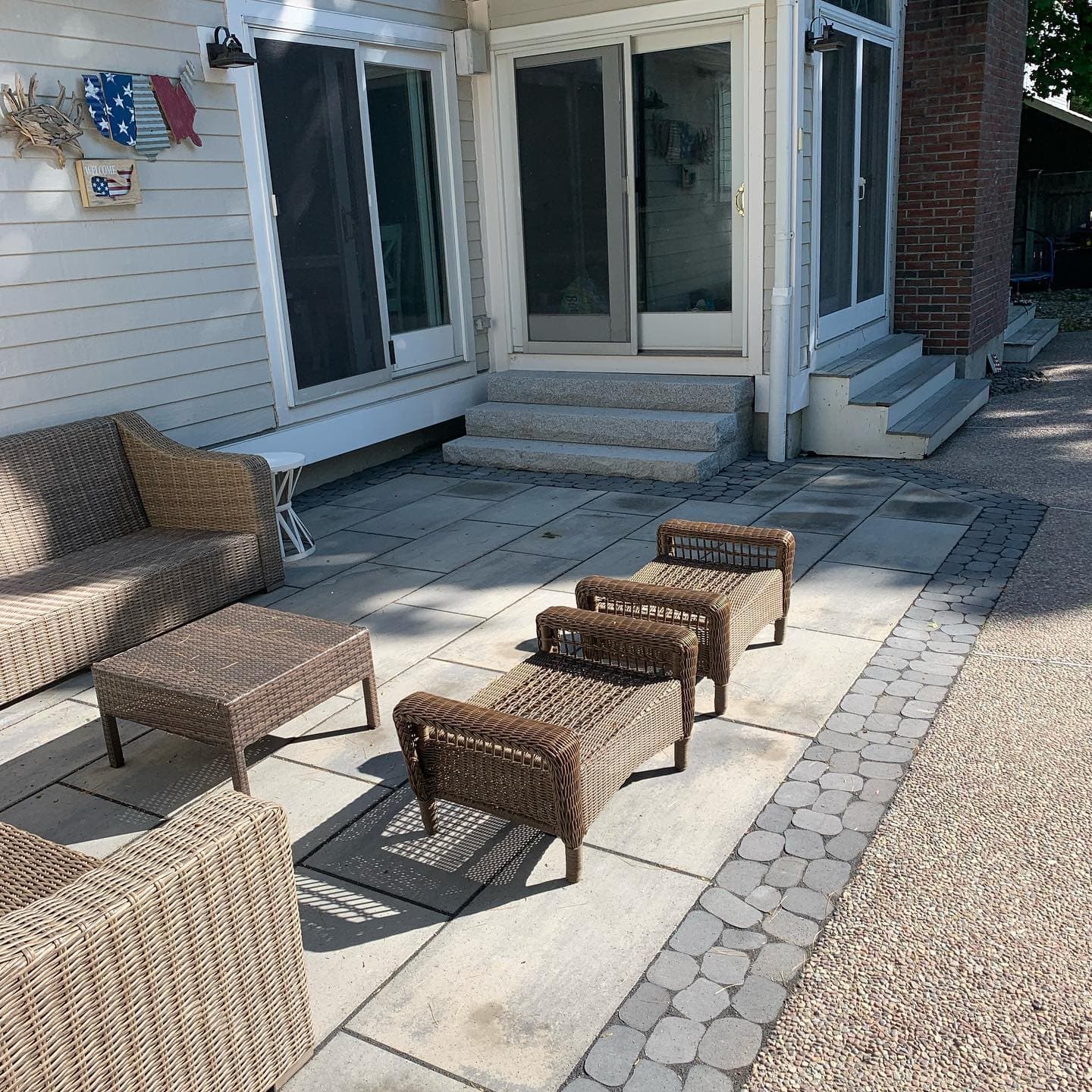Bluestone-look patio with cobble border and outdoor furniture